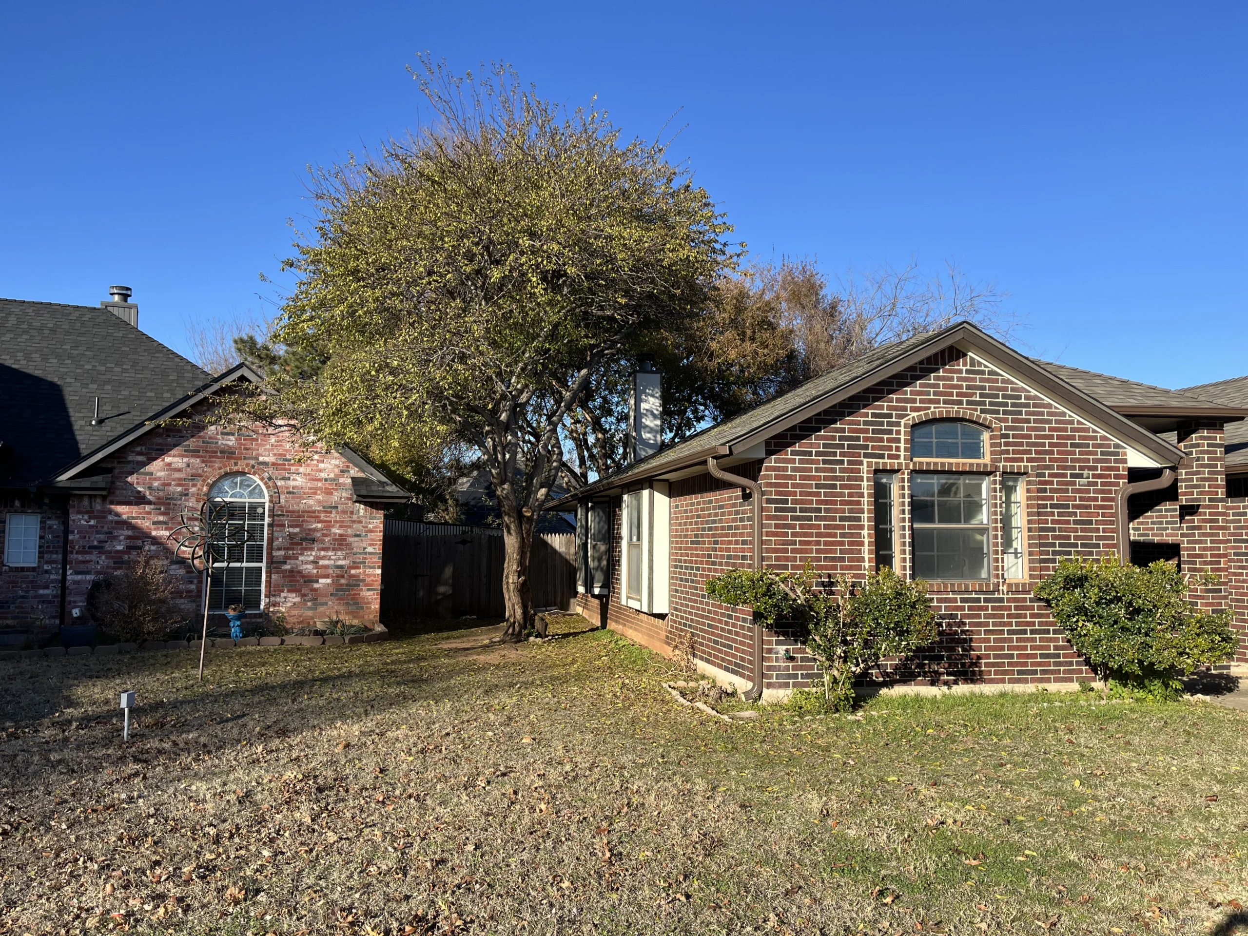 a dark bricked home recently upgraded with customer gutters