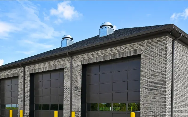 800x450 dark brown roof with dark and light bricked commercial building with dark brown custom gutters