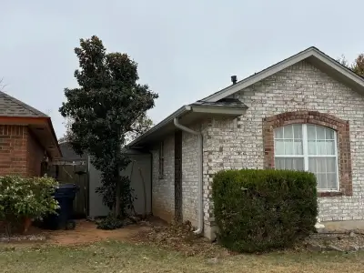 Brick/stone home with newly installed complimentary functional gutter system